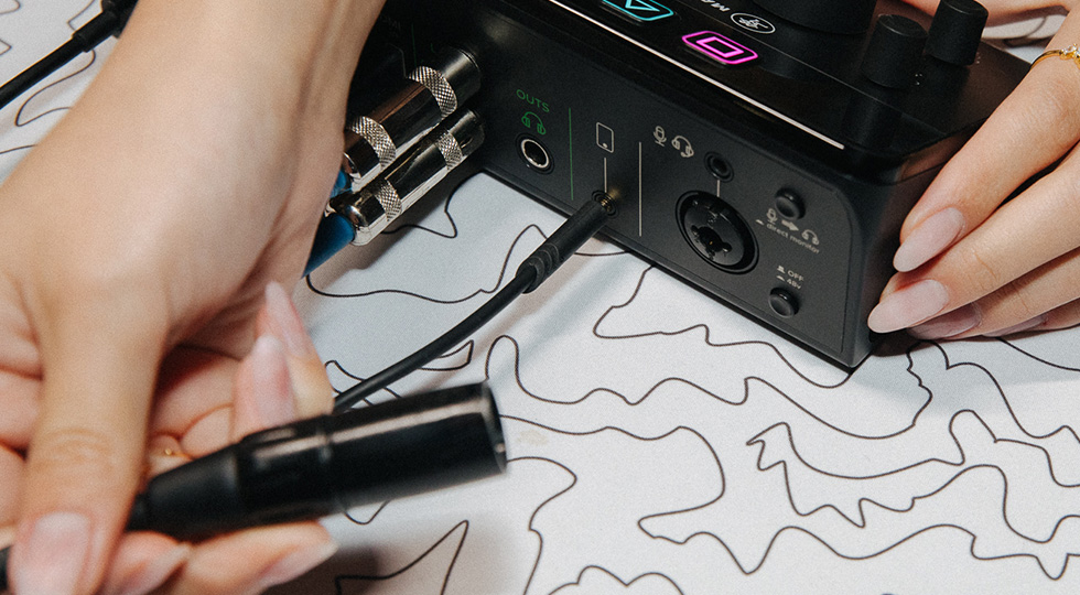 Photo of hand pluging in a cable into the DLZ Creator XS
